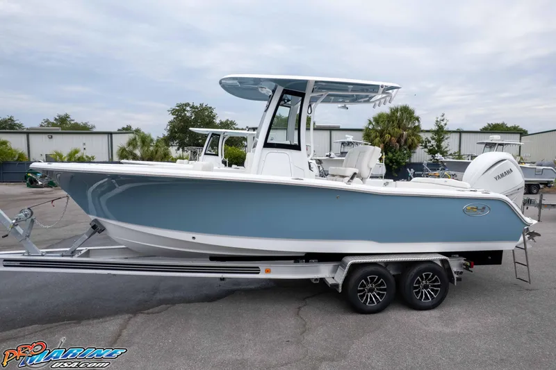 Slide: The Image of 2026 Sea Hunt Ultra 245 SE boat on trailer, side view, in outdoor setting. - 3