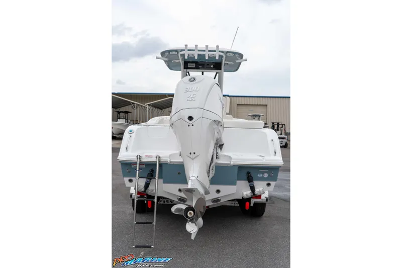 Slide: The Image of 2026 Sea Hunt Ultra 245 SE boat rear view with outboard motor and ladder. - 30