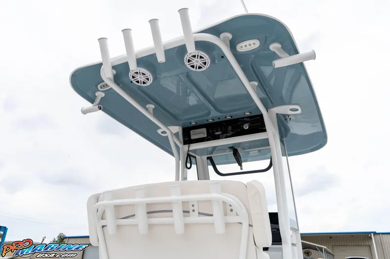 Slide: The Image of 2026 Sea Hunt Ultra 245 SE boat with blue T-top and rod holders. - 34