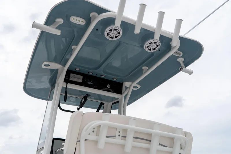 Slide: The Image of 2026 Sea Hunt Ultra 245 SE boat with blue T-top and rod holders. - 36
