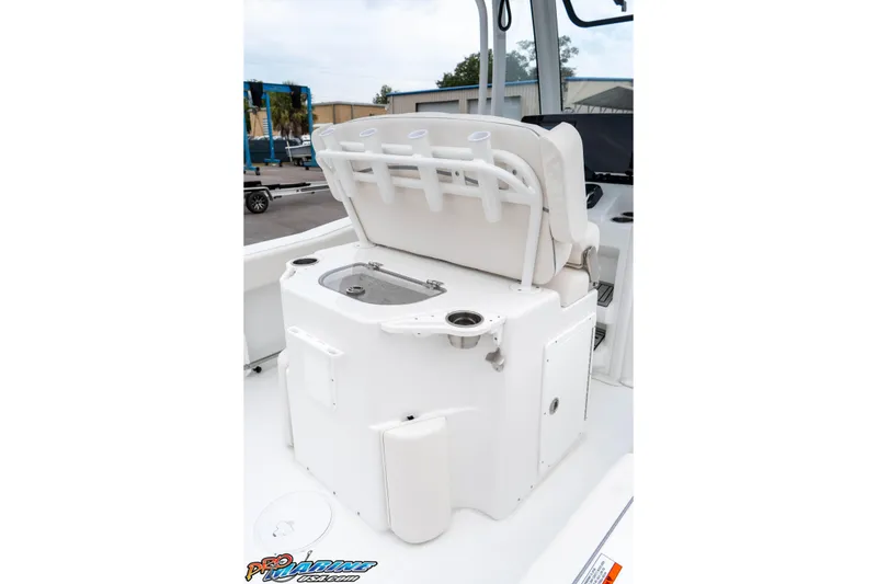 Slide: The Image of 2026 Sea Hunt Ultra 245 SE boat interior with open storage compartment and rod holders. - 39