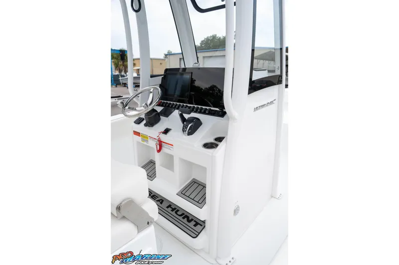 Slide: The Image of 2026 Sea Hunt Ultra 245 SE boat console with steering wheel and electronic controls. - 41
