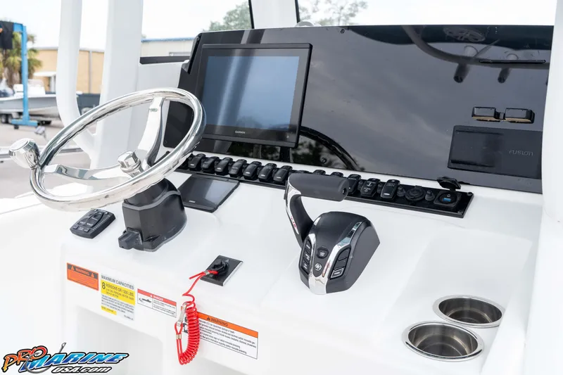 Slide: The Image of 2026 Sea Hunt Ultra 245 SE boat dashboard with steering wheel and controls. - 42