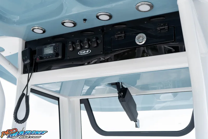 Slide: The Image of 2026 Sea Hunt Ultra 245 SE boat console with Garmin electronics and overhead storage. - 43