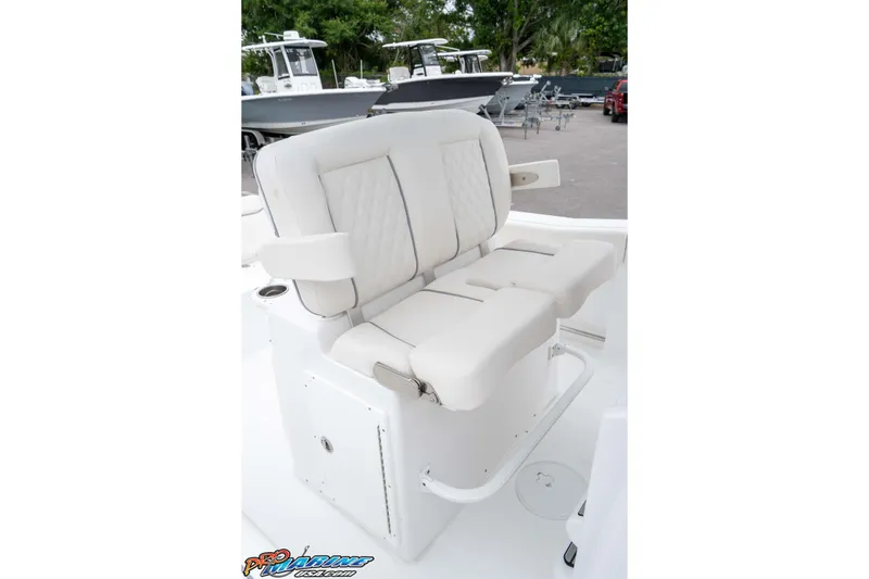 Slide: The Image of 2026 Sea Hunt Ultra 245 SE boat seat, white cushioned design, outdoor setting. - 45