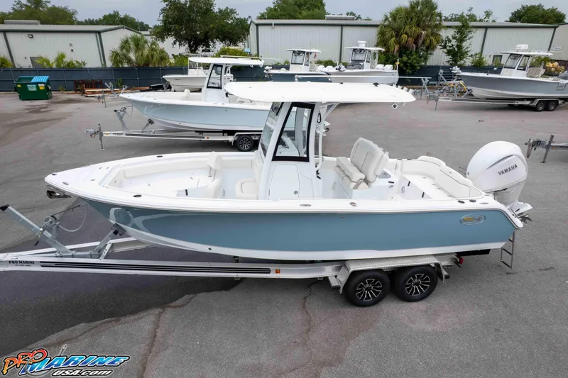 Slide: The Image of 2026 Sea Hunt Ultra 245 SE boat on trailer, displayed outdoors. - 5