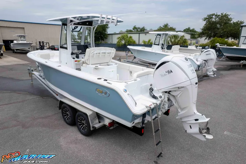 Slide: The Image of 2026 Sea Hunt Ultra 245 SE boat with Yamaha engine on trailer in marina. - 7