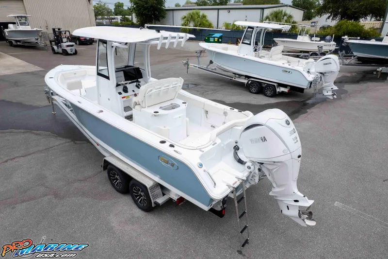 Slide: The Image of 2026 Sea Hunt Ultra 245 SE boat with Yamaha engine on trailer in marina. - 8