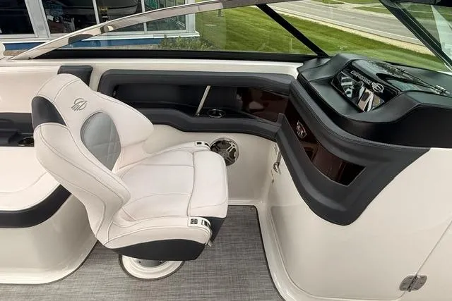 Slide: The Image of 2019 Chaparral 277 SSX boat interior with white captain's chair and sleek dashboard design. - 12