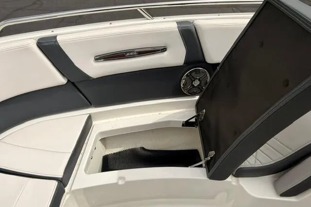 Slide: The Image of 2019 Chaparral 277 SSX boat interior with open storage compartment and speaker. - 20