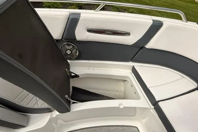 Slide: The Image of 2019 Chaparral 277 SSX boat interior with open storage compartment and seating. - 21