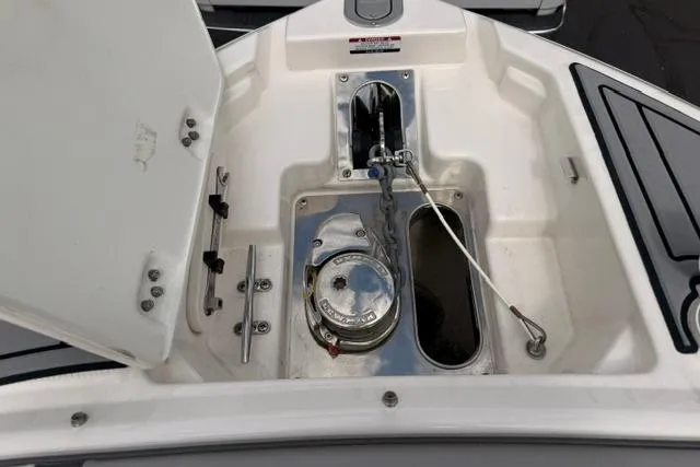 Slide: The Image of 2019 Chaparral 277 SSX boat anchor compartment with stainless steel fittings and storage space. - 23