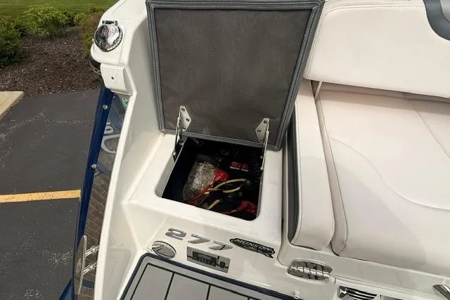 Slide: The Image of 2019 Chaparral 277 SSX boat storage compartment open, revealing interior contents. - 35