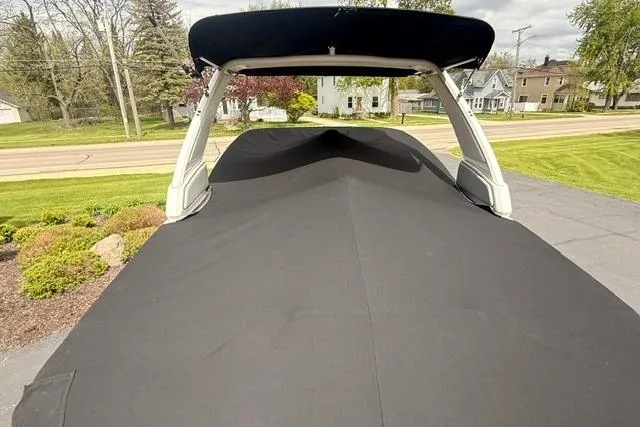 Slide: The Image of 2019 Chaparral 277 SSX boat covered with black tarp, parked outdoors. - 42