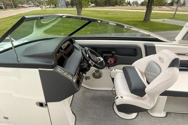 Slide: The Image of 2019 Chaparral 277 SSX boat cockpit with steering wheel and captain's chair. - 6