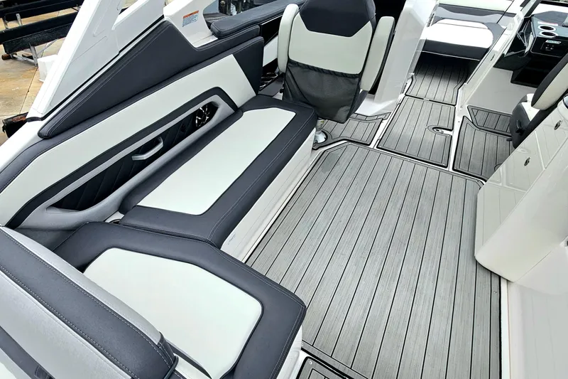 Slide: The Image of 2023 Yamaha Boats 275SDX interior with sleek seating and modern flooring design. - 13