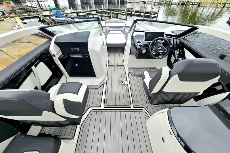 Slide: The Image of 2023 Yamaha Boats 275SDX interior with sleek seating and modern dashboard design. - 14