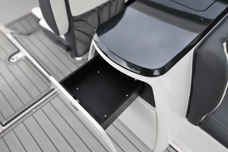 Slide: The Image of Open storage drawer on 2023 Yamaha Boats 275SDX, showcasing sleek interior design. - 18