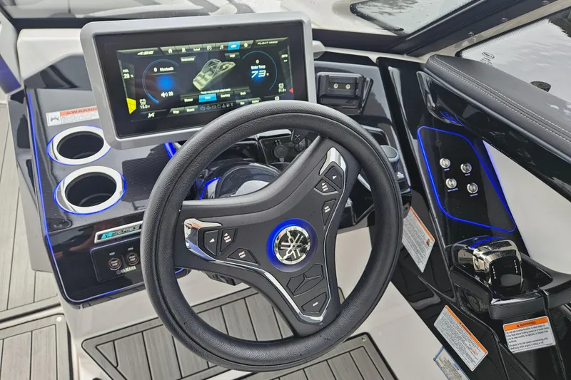 Slide: The Image of 2023 Yamaha Boats 275SDX dashboard with steering wheel and digital display. - 19