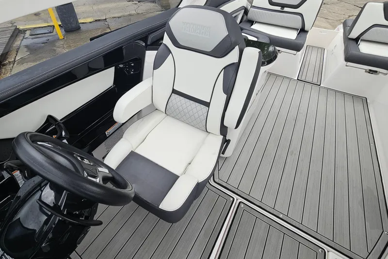 Slide: The Image of 2023 Yamaha Boats 275SDX interior with sleek seating and modern steering wheel design. - 20