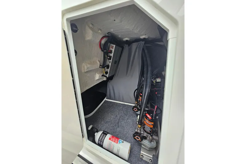 Slide: The Image of 2023 Yamaha Boats 275SDX engine compartment with wiring and fire extinguisher. - 22