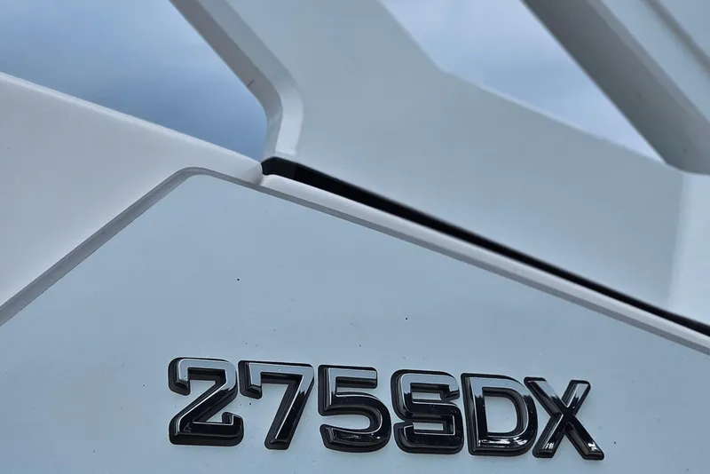 Slide: The Image of 2023 Yamaha Boats 275SDX logo on sleek white surface. - 3