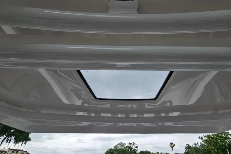 Slide: The Image of 2023 Yamaha Boats 275SDX sunroof view, showcasing sleek design and outdoor scenery. - 30