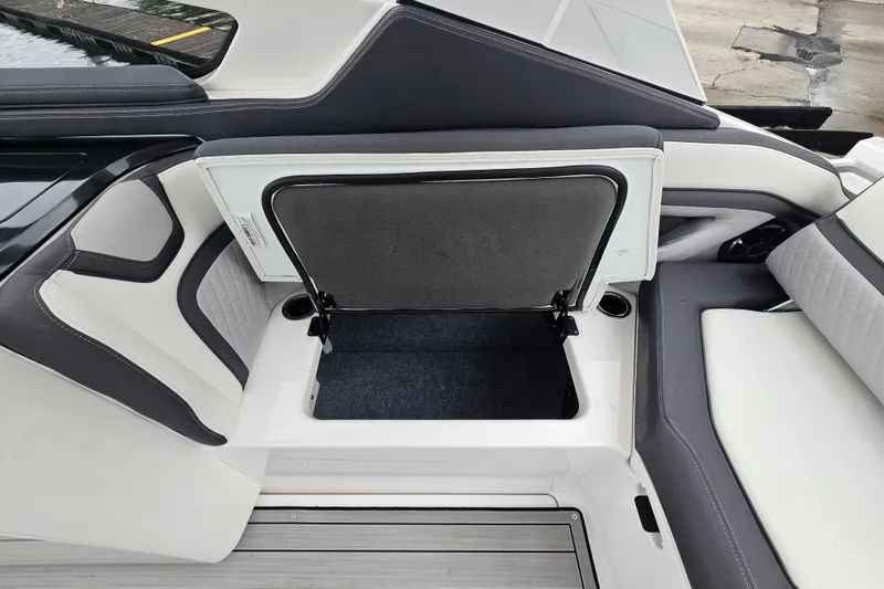 Slide: The Image of 2023 Yamaha Boats 275SDX storage compartment with open lid, showcasing interior space. - 31