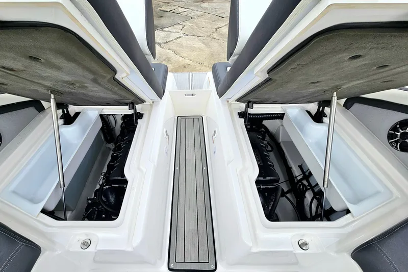 Slide: The Image of 2023 Yamaha Boats 275SDX engine compartment with open hatches, showcasing interior components. - 34