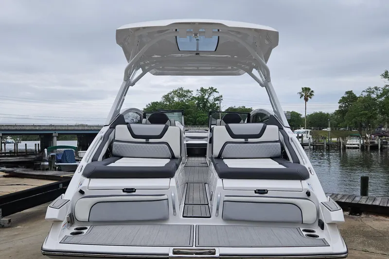 Slide: The Image of 2023 Yamaha Boats 275SDX at dock, showcasing sleek design and spacious seating. - 5