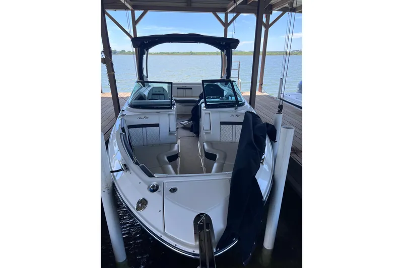 The Image of 2018 Sea Ray SLX 250 boat docked, featuring sleek design and spacious seating. - 1