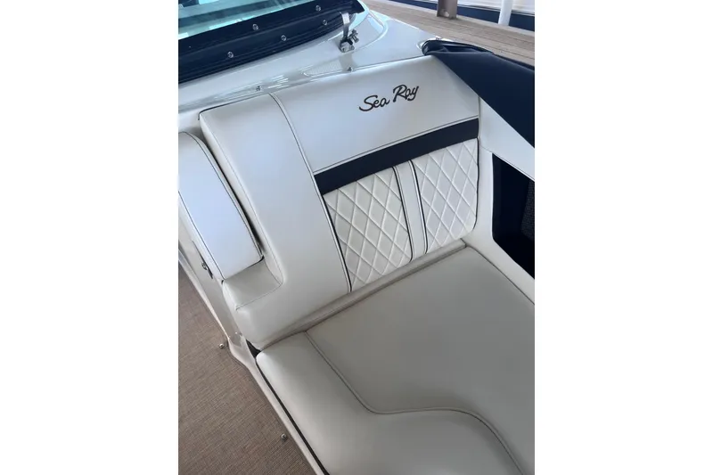 Slide: The Image of 2018 Sea Ray SLX 250 boat interior with elegant white leather seating and quilted design. - 12