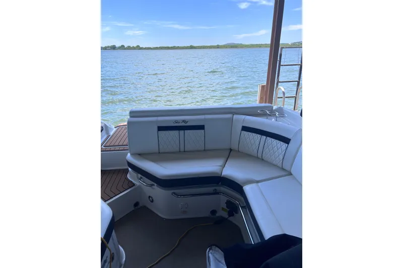 Slide: The Image of 2018 Sea Ray SLX 250 boat interior with white seating, overlooking a serene lake. - 14