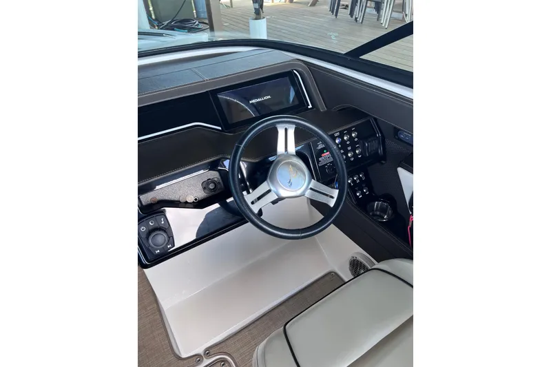 Slide: The Image of 2018 Sea Ray SLX 250 boat dashboard with steering wheel and control panel. - 19