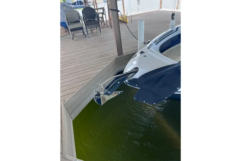 Slide: The Image of 2018 Sea Ray SLX 250 boat docked, featuring sleek design and modern amenities. - 21