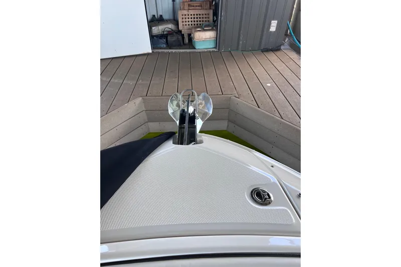 Slide: The Image of Bow of a 2018 Sea Ray SLX 250 boat docked on wooden deck. - 23