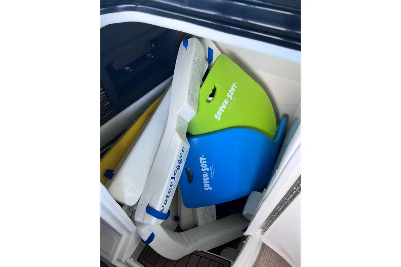 Slide: The Image of Storage compartment in a 2018 Sea Ray SLX 250 boat with colorful water floats. - 25
