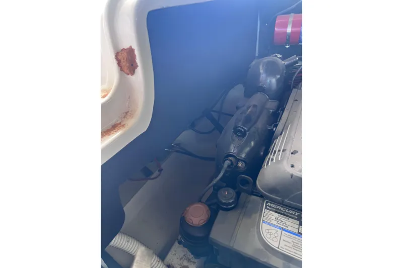 Slide: The Image of Engine compartment of a 2018 Sea Ray SLX 250 boat, showing Mercury components. - 30