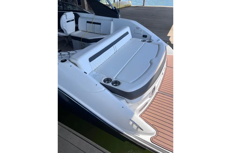 Slide: The Image of 2018 Sea Ray SLX 250 boat with spacious seating and sleek design at a dock. - 7