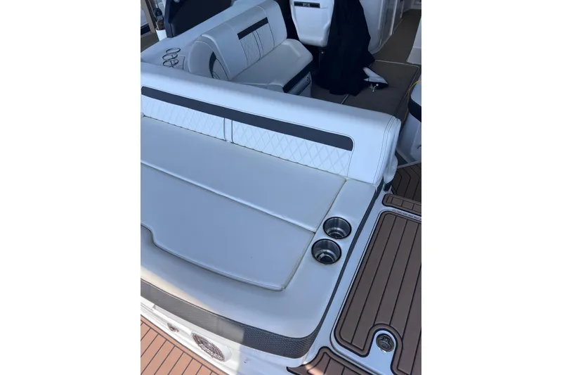 Slide: The Image of 2018 Sea Ray SLX 250 boat interior with white seating and cup holders. - 8