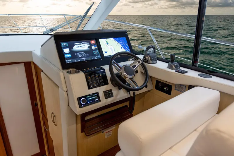 Slide: The Image of Manufacturer Provided Image: 2026 Regal 42 Grande Coupe helm with modern navigation system, steering wheel, and ocean view. - 5
