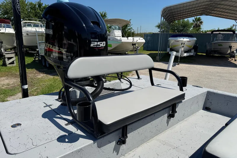 Slide: The Image of 2016 El Pescador 24 CAT boat with Yamaha 250 engine, featuring a cushioned bench seat. - 16
