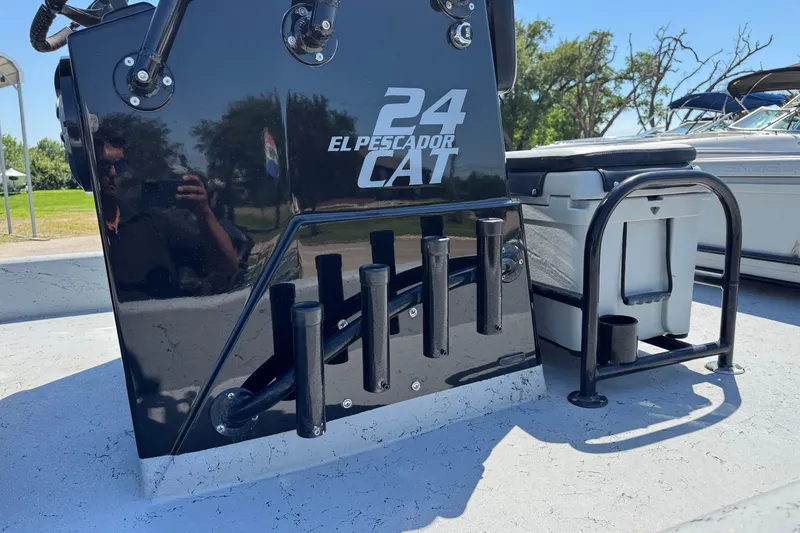 Slide: The Image of 2016 El Pescador 24 CAT boat console with rod holders and cooler on deck. - 19