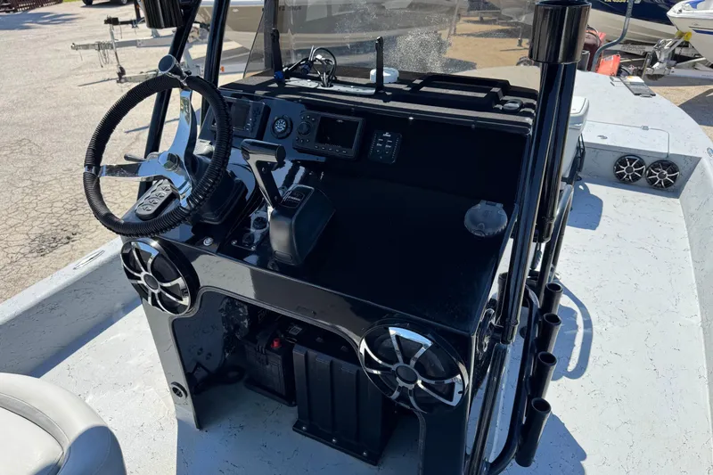 Slide: The Image of 2016 El Pescador 24 CAT boat dashboard with steering wheel and controls. - 21