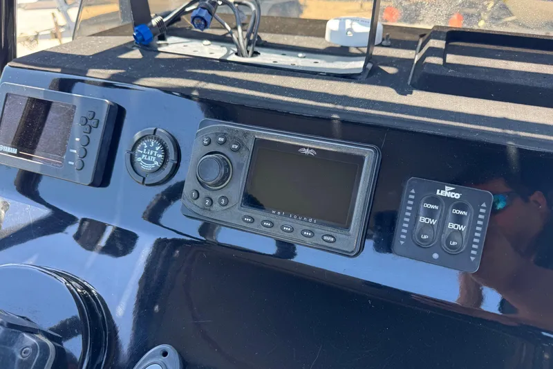 Slide: The Image of Dashboard of a 2016 El Pescador 24 CAT boat with navigation controls. - 22