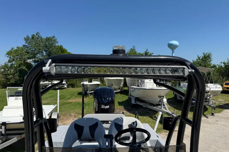 Slide: The Image of 2016 El Pescador 24 CAT boat with light bar, parked among other boats. - 32
