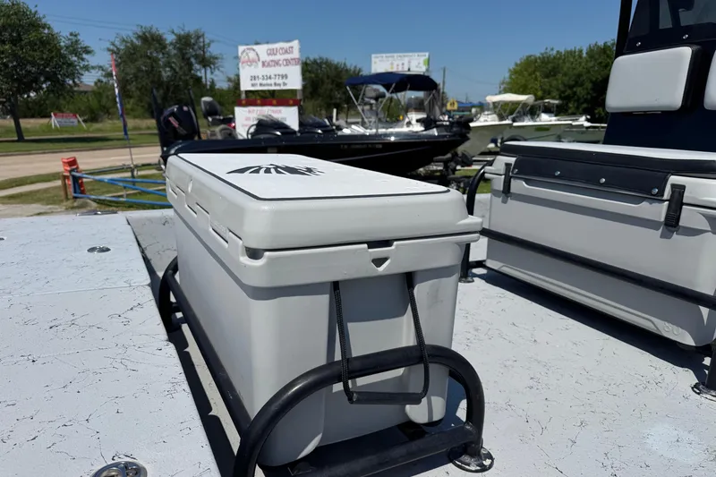 Slide: The Image of 2016 El Pescador 24 CAT boat with cooler on deck, Gulf Coast Boating Center in background. - 4