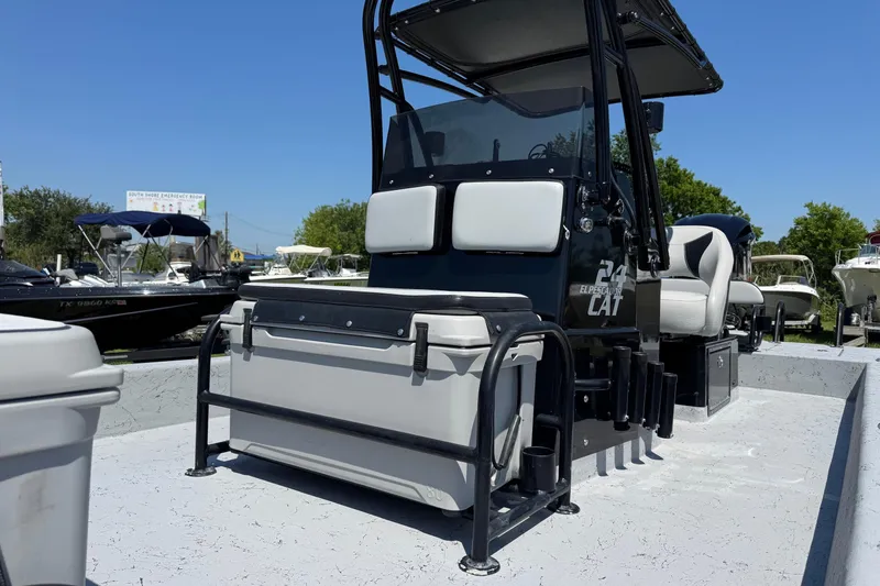 Slide: The Image of 2016 El Pescador 24 CAT boat with seating and storage, displayed outdoors. - 5