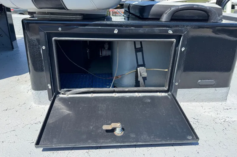 Slide: The Image of Open storage compartment on a 2016 El Pescador 24 CAT boat, showing interior wiring. - 8