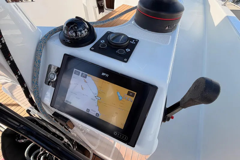 Slide: The Image of Navigation console of 2025 Jeanneau Sun Odyssey 350 sailboat with compass and display. - 22